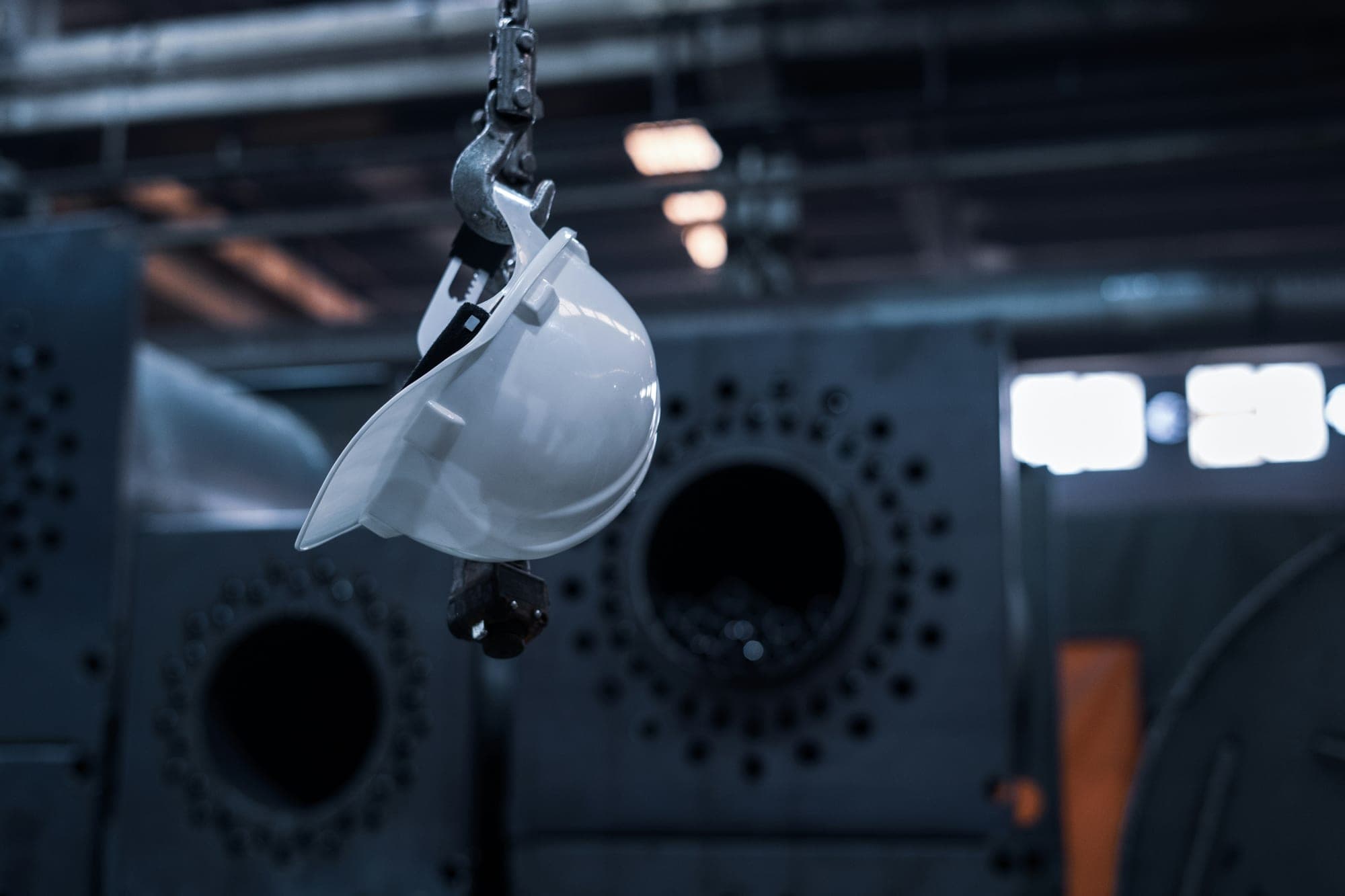 A hard hat hanging from an overhead hook
